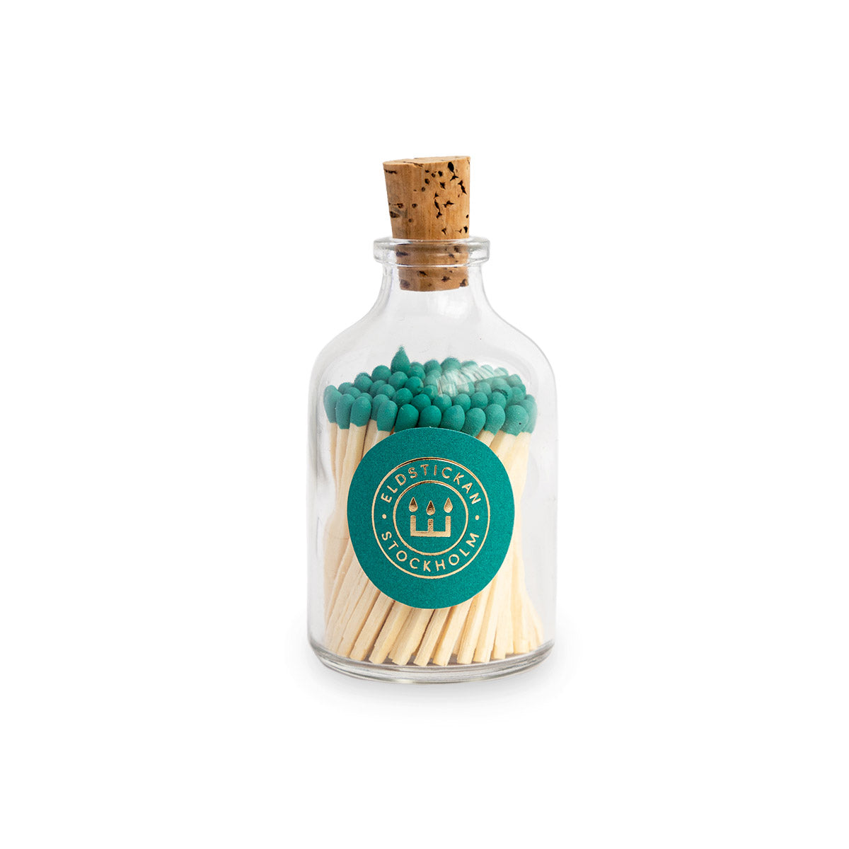Fyrstikker petroleumgrønn rundt glass Eldstickan